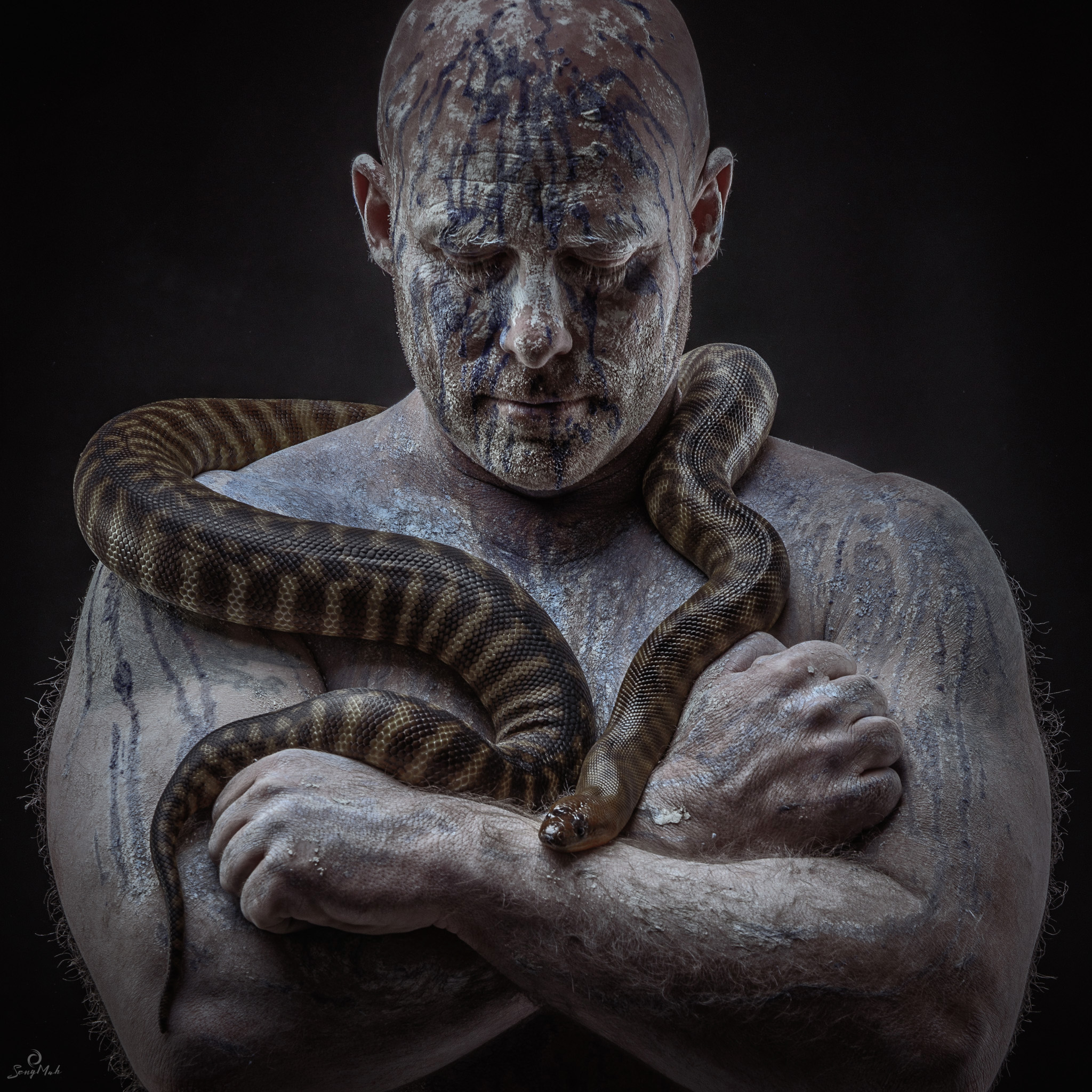 Clayed up man with snake