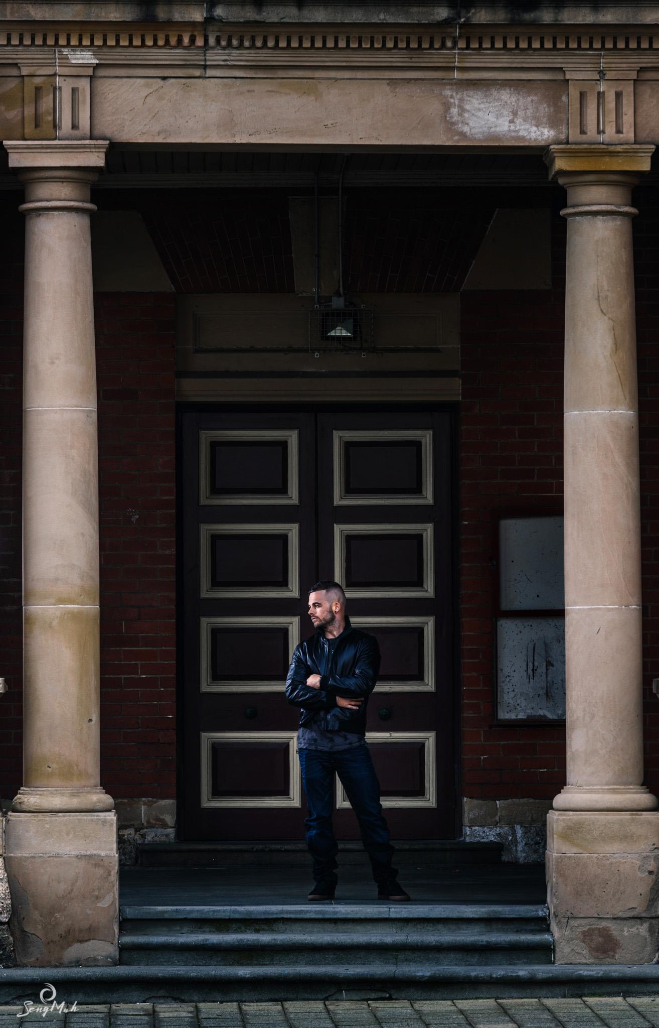 Man standing between columns