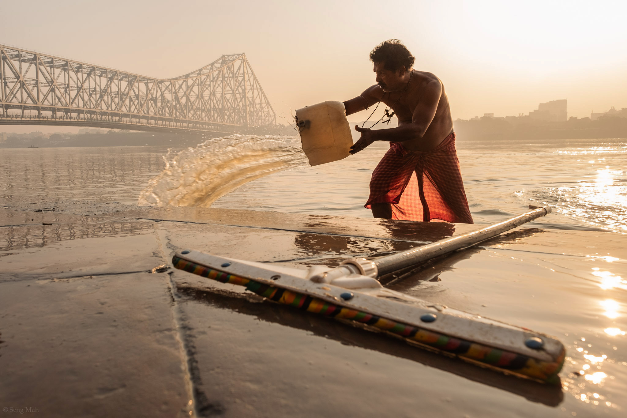 Man washing the ghats at sunrise