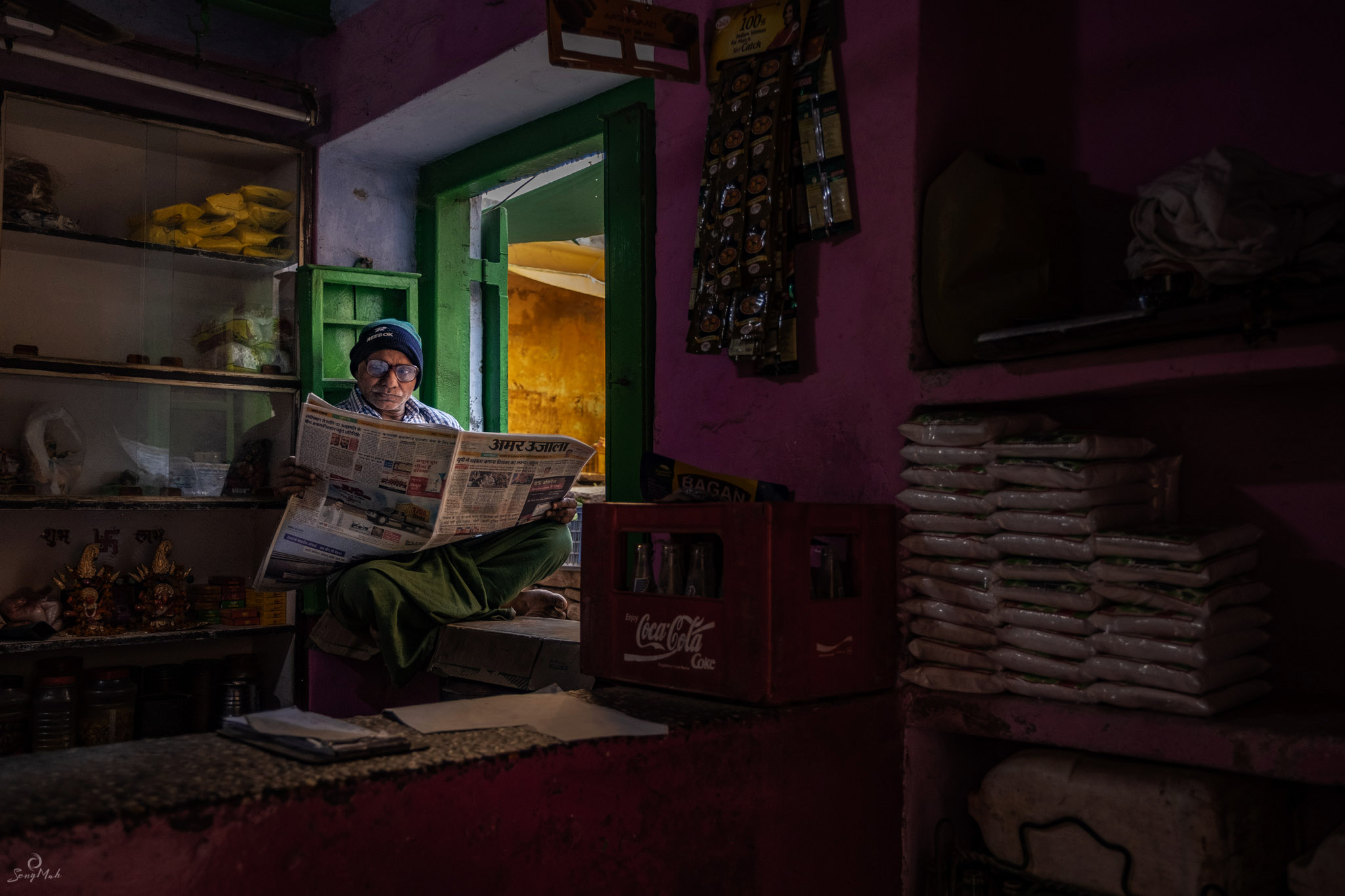 Interior scene of man reading newspaper in shop