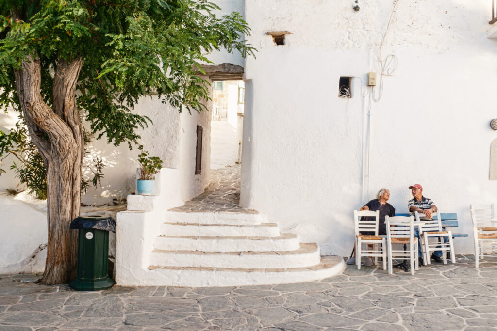 Folegandros Chora; two locals having a conversation outside the gate to the Castro.
